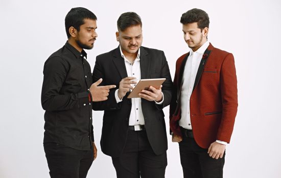 Isolated. Three men discussing ideas. White background. Indian nationality.